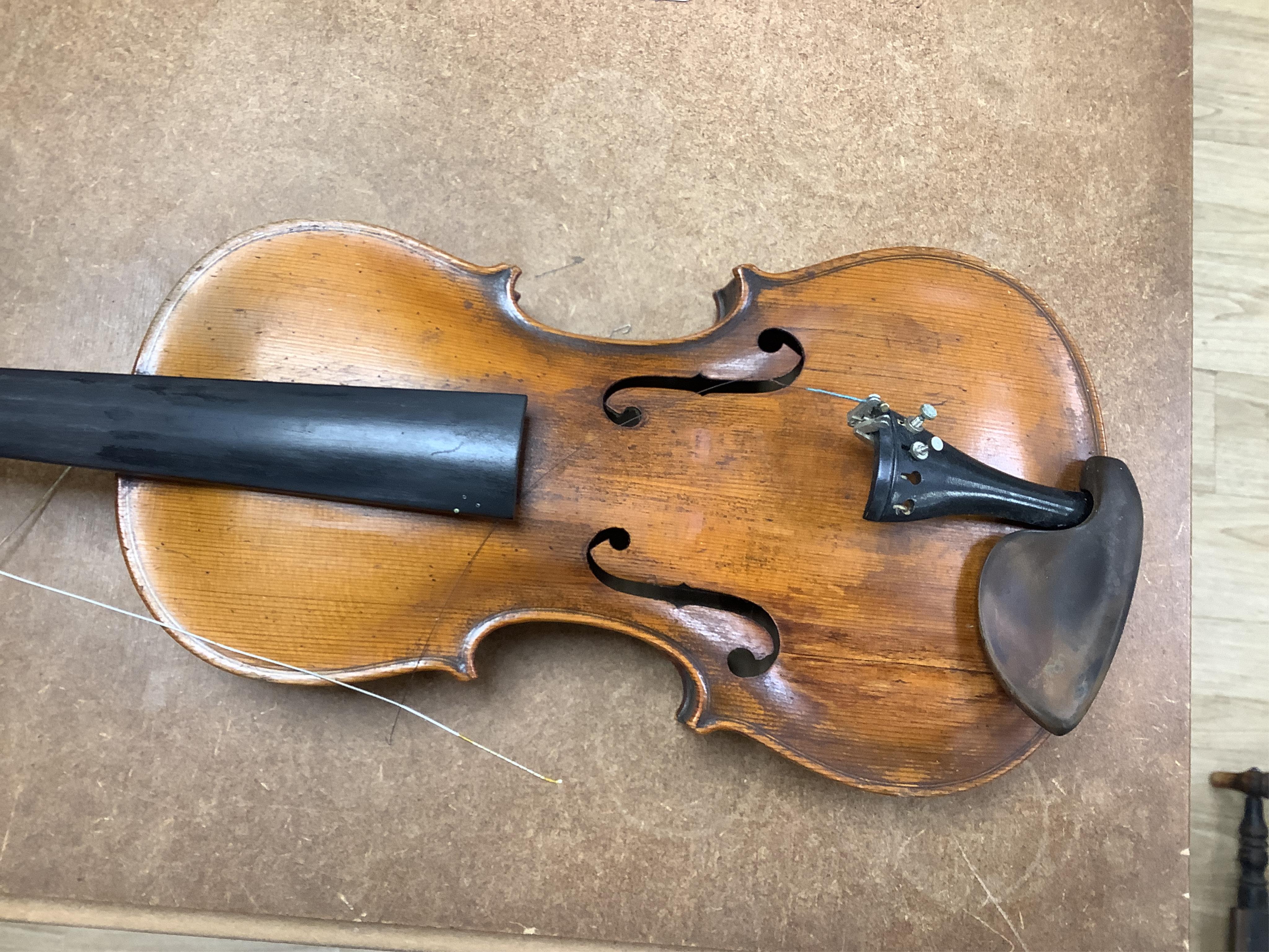 A cased 7/8 size 19th century violin, body 35cm, together with another cased violin, body 35.5cm, both without bows, and a spare case (3)